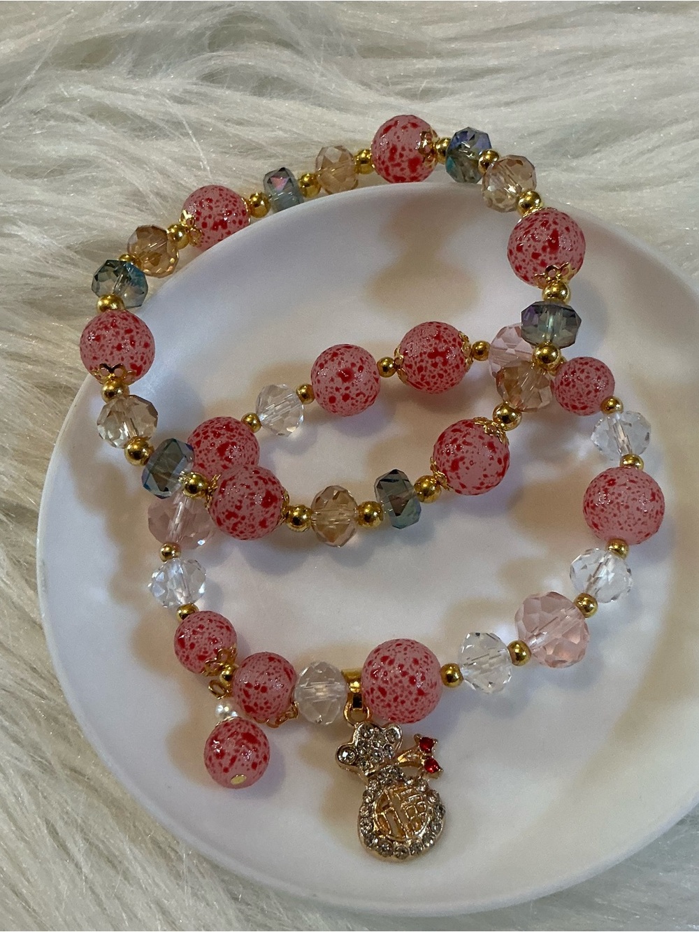 Two super pretty pink speckled bead bracelets with gold-tone Asian charm